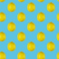 Seamless pattern of lemons isolated on blue. Food background