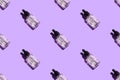 Seamless pattern of liquid oil serum bottle isolated on violet background. Retinol, aha acid, collagen skincare fluid in