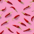 Seamless pattern made of red chili or chilli on pink background. Minimal food pattern. Red hot chilli seamless peppers pattern. Royalty Free Stock Photo