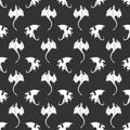 Seamless pattern made up of white dragons and wyverns on the black background. Royalty Free Stock Photo