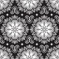 Seamless pattern mehndi background with flowers and lace buta decoration items on black background.