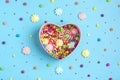 Seamless pattern of mix colorful sweets - lollipop, meringue, chocolate, sprinkle, gift box shape of heart, blue background Royalty Free Stock Photo