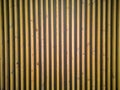 Seamless pattern of modern wall paneling with vertical wooden slats for background. Raw material of natural brown wood lath Royalty Free Stock Photo