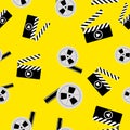 Seamless pattern of movie clapperboard and a reel of tape. Vector illustration.