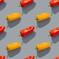 Seamless pattern of multi-colored bell peppers with shadow on a gray background. Red and yellow hot peppers form a pattern on a