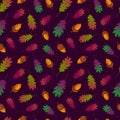 Seamless pattern with multicolored autumn oak leaves and golden acorns on dark background. Green, purple, burgundy, yellow color.