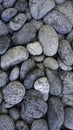 Seamless pattern of natural grey river pebbles for background texture Royalty Free Stock Photo
