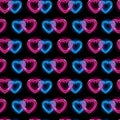 Seamless pattern with neon icons of blue and pink interwined hearts on black background. St. Valentine's Day, wedding Royalty Free Stock Photo