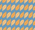Seamless pattern with orange feathers on blue background Royalty Free Stock Photo