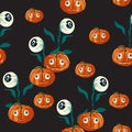 Seamless pattern with orange Halloween pumpkins carved faces and eyed on black background. Royalty Free Stock Photo