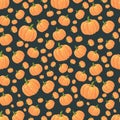 Seamless pattern orange isolated pumpkins on a dark background