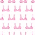 Seamless pattern with pink cancer ribbons on bras. Breast Cancer Awareness Month pink and white background. Cancer ribbon symbol. Royalty Free Stock Photo