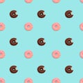 Seamless pattern with pink glazed donuts and chocolate glazed bitten donuts Royalty Free Stock Photo