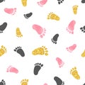 Seamless pattern with pink and golden baby footprints. Royalty Free Stock Photo