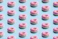 Seamless Pattern Of pink Topping Donuts On Pastel blue Background. design trendy food concept Royalty Free Stock Photo