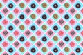 Pattern of pink, white and chocolate donuts on multi-colored striped background top view, tasty doughnuts backdrop Royalty Free Stock Photo