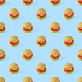 Seamless pattern of plastic childrens toy burger with salad, tomato, meat on blue background. Toy burger. Plastic hamburger. Food