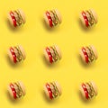 Plastic childrens toy burger with salad, tomato, meat with on pastel blue background. Concept of harmful artificial food.