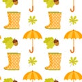 Seamless pattern with polka dot rubber boots, umbrella, oak leaves, acorn Royalty Free Stock Photo