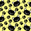 Seamless pattern, print, muzzles of cute black cats and paw prints on a yellow background. Textiles, decor for kids bedroom Royalty Free Stock Photo