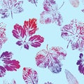 Seamless pattern of prints of red-blue leaves on a blue background. Vector