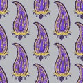 Seamless pattern with purple and yellow Paisley motifs on gray background Royalty Free Stock Photo