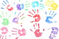 Seamless pattern with rainbow colored kids hand prints on white background