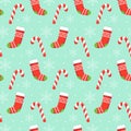 Seamless pattern with red Christmas stockings, candys and snowflakes on blue background. Christmas, winter concept for wrapping, Royalty Free Stock Photo