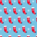 Seamless pattern with red Christmas stockings and snowflakes on blue background. Christmas, winter concept for wrapping, wallpaper Royalty Free Stock Photo