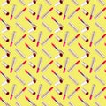 Seamless pattern of red lipstick in golden tube on yellow background isolated, shiny gold open and closed pink lipsticks, cosmetic
