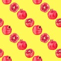 Seamless pattern of red pomegranates in rows on yellow background isolated, whole and cut pomegranate repeating striped ornament