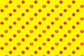 Pattern of red tomatoes on bright yellow background top view, colorful cut and whole tomato wallpaper, fresh vegetables Royalty Free Stock Photo