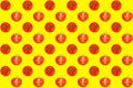 Seamless pattern of red tomatoes on bright yellow background top view, colorful cut and whole tomato wallpaper, fresh vegetables Royalty Free Stock Photo