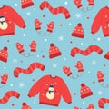 Seamless pattern of red winter hat, mittens, scarf and sweater. Winter elements on blue background. Doodle style. Royalty Free Stock Photo