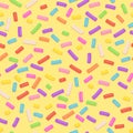 Seamless pattern repeating seamless texture of yellow donut glaze with many decorative sprinkles.Vector confectioners icing for ca