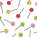 Seamless pattern with round cartoon lollipops on white