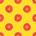 Seamless pattern from round slices of ripe juicy pink grapefruit on yellow background. Poster banner template Royalty Free Stock Photo