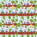 Seamless pattern set bright colorful owls on the branch of a tree with red apples on blue background. Vector Royalty Free Stock Photo
