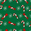 Seamless pattern, set of cute hand-drawn red and white sweets, candies and white snowflakes on green background. Winter, christmas