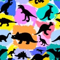 Seamless pattern with silhouettes of dinosaurs and watercolor colorful spots. Preistoric animals. Vector background. Royalty Free Stock Photo