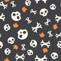 Seamless pattern with skulls, bones and autumn leaves. Halloween background