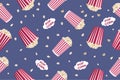 Seamless pattern with striped popcorn box, popcorn grains on a blue background. Movie junk food. Vector illustration Royalty Free Stock Photo