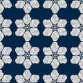 Seamless pattern. Stylized snowflakes, flowers or stars, white elements on a blue background. Ornate scrollwork. Hand drawn vector