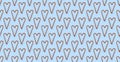 Seamless Pattern of Traditional Christmas candy cane lollipop shape of heart on blue background flat lay top view Royalty Free Stock Photo