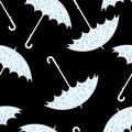 Seamless pattern with umbrellas in the rain on black background. Royalty Free Stock Photo