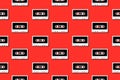 Seamless pattern with vintage white audio tape cassette concept illustration isolated on red background Royalty Free Stock Photo