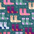 Seamless pattern with warm socks with different texture and color. Vector winter hand drawn socks. Christmas