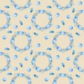 Seamless pattern with watercolor drawings of a blue Easter wreath with bird eggs, twigs, and feathers on a beige background. Royalty Free Stock Photo