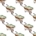 Seamless pattern. Wheelbarrow brown with red flowers and green leaves.