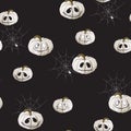 Seamless pattern with white Halloween pumpkins carved faces and spider on black background. Royalty Free Stock Photo